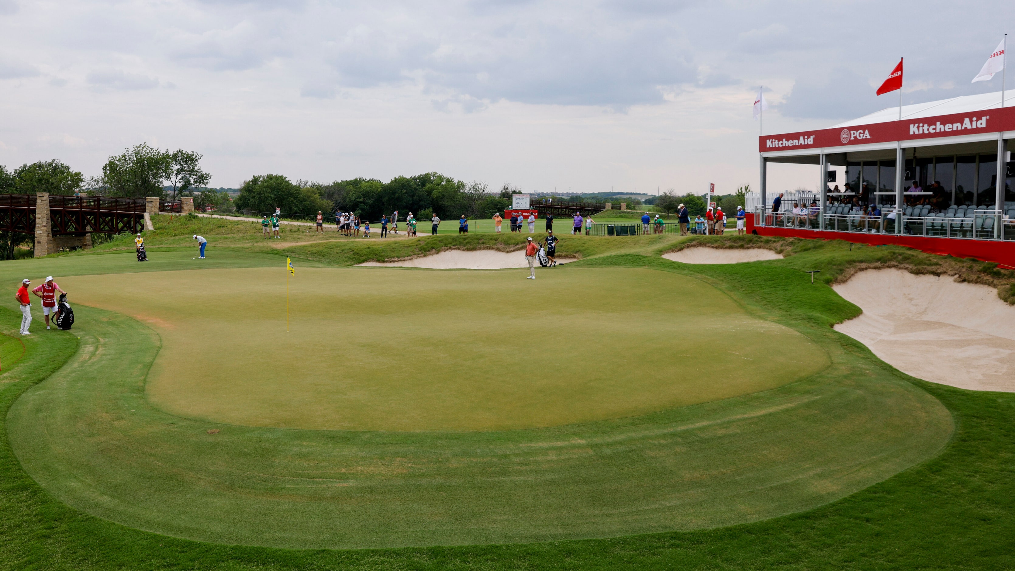 The group of K.J. Choi, Steve Stricker and Mark Hensby ready themselves to putt on the 18th...