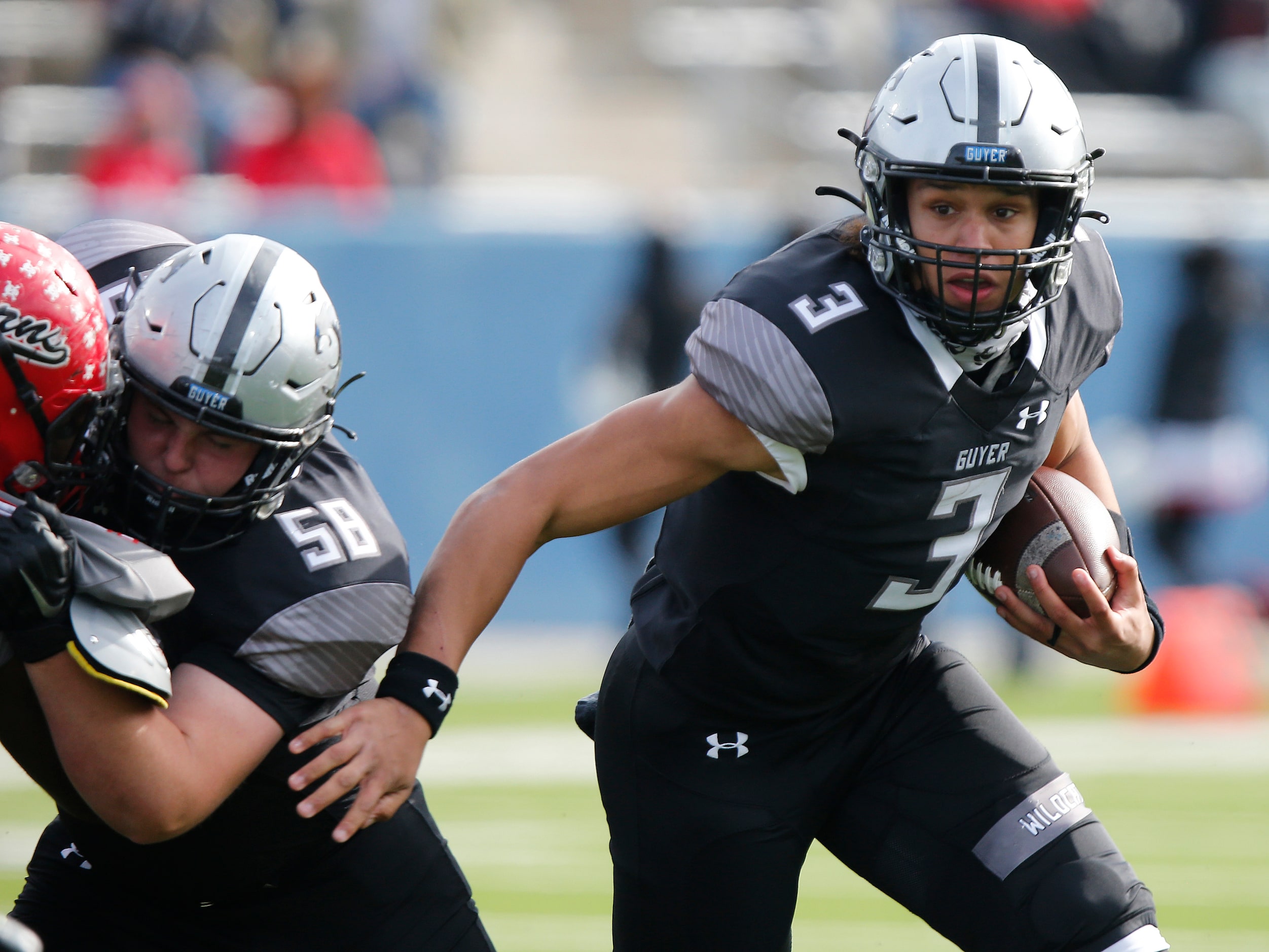 Denton Guyer High School quarterback Eli Stowers (3) runs the football behind a block from...