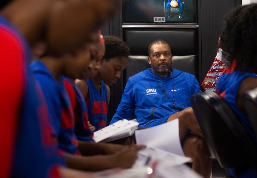 Travis Mays (center), head coach of SMU women's basketball, watches his team as they take...