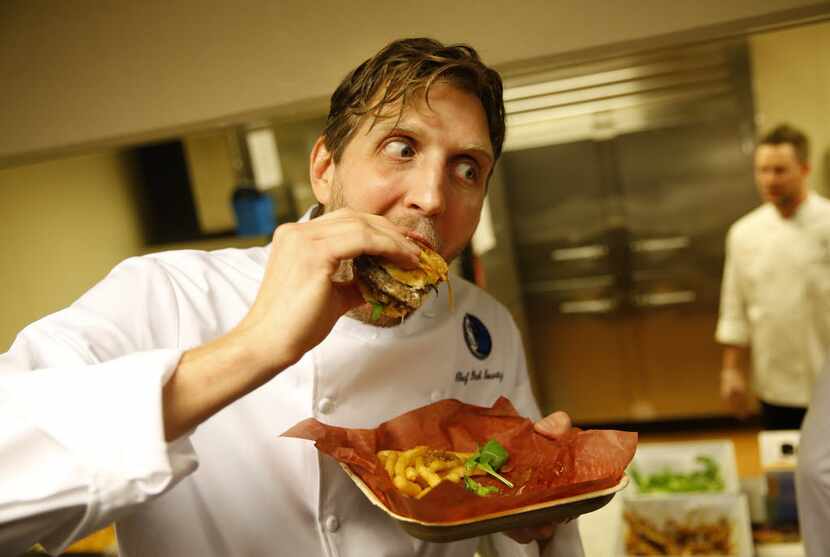FILE - Dirk Nowitzki poses for photographers with the Dirkburger, a burger named after him...