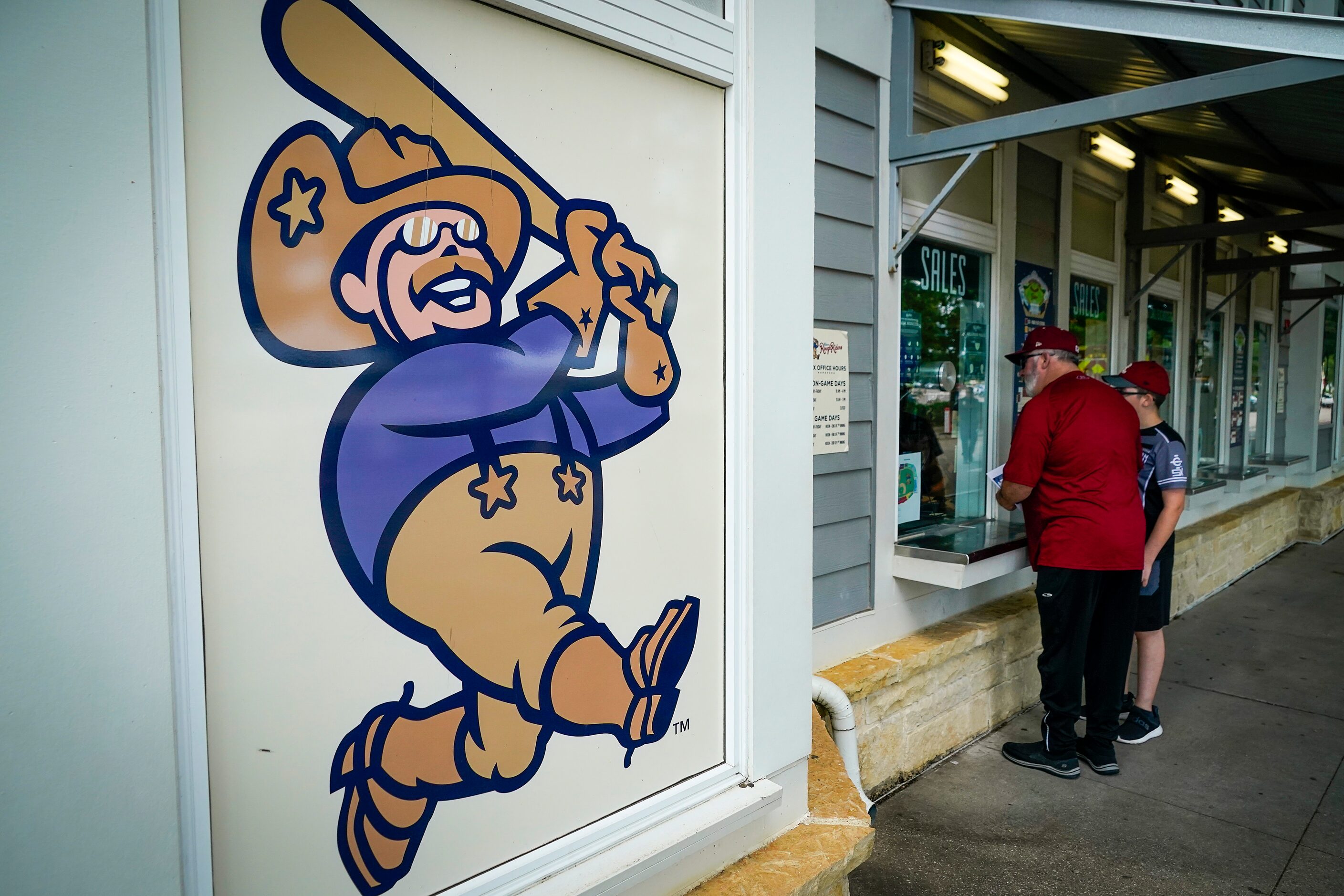 Fans visit the ticket window before the Frisco RoughRiders season opener against the Midland...