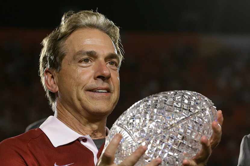 Alabama head coach Nick Saban holds The Coaches Trophy after the BCS National Championship...