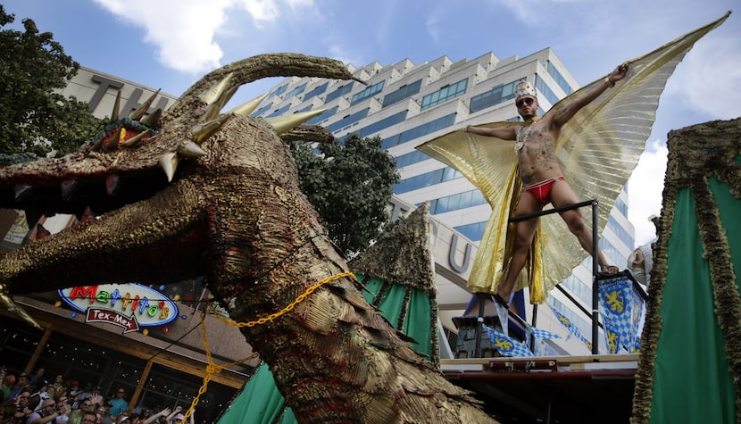 Mateo Vences spreads his wings atop a large dragon on the Club Kaliente float in the Alan...