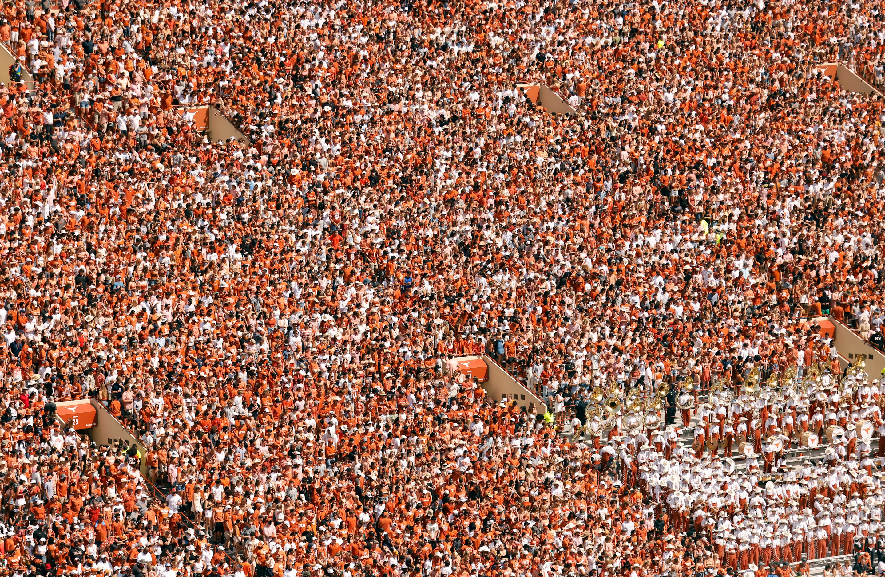 The Texas Longhorn Band (lower right) is surrounded by a sea of students on the east side of...