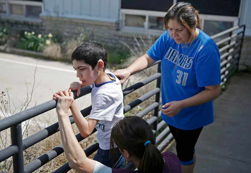 
Laura Lopez (right), with Jonathan and therapist Immitt, says the Equest program “has been...