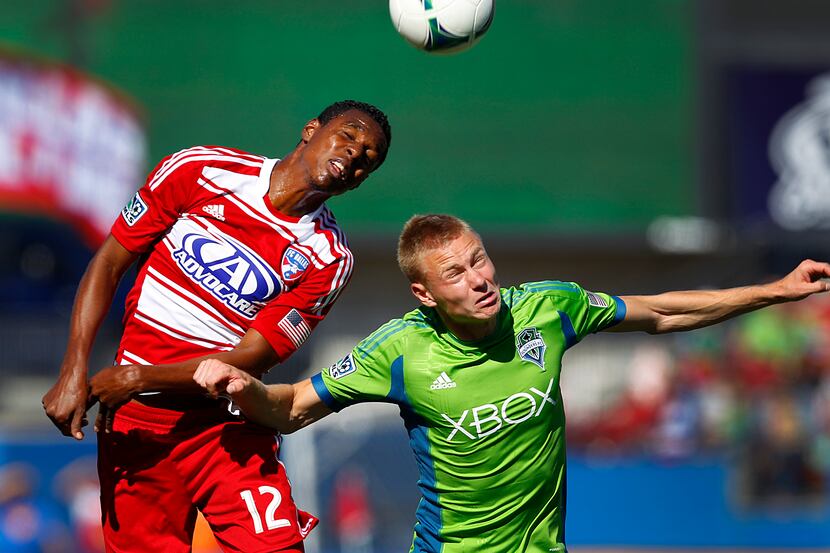 FC Dallas midfielder Erick (12) and Seattle Sounders FC midfielder Andy Rose (25) go for a...