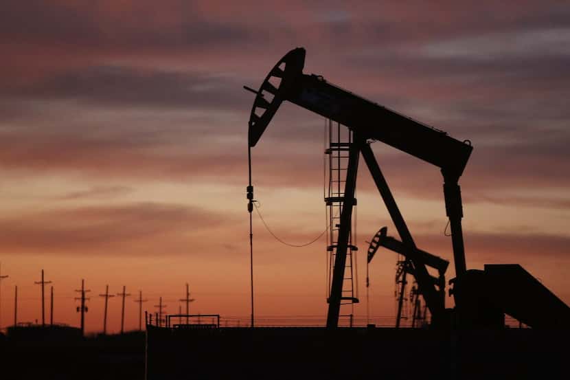An oil pumpjack works at dawn in the Permian Basin oil field on Jan. 20, in the oil town of...