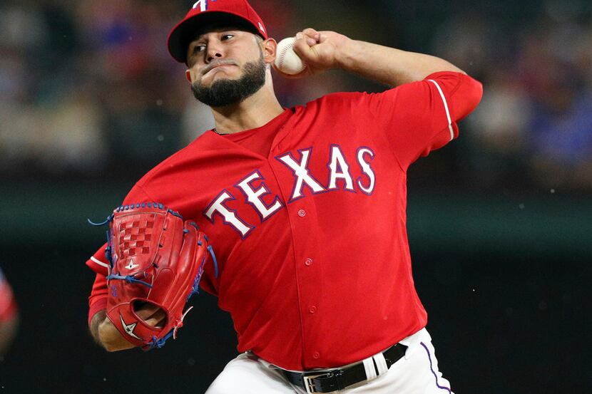 Texas Rangers starting pitcher Martin Perez throws during the first inning of the team's...