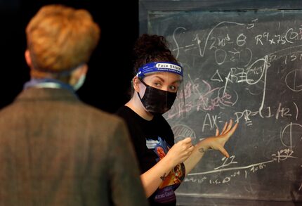 Director Ashley White talks to Oppenheimer played by Evan Michael Woods (left) during a...