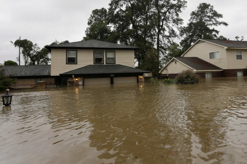Floodwaters from Harvey surrounded homes Monday in Spring. (David J. Phillip/The Associated...