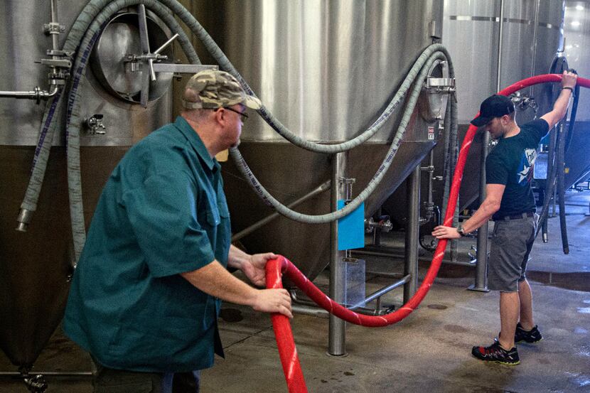 Gary James (left) helps Rahr & Sons Brewing Company employee Derek Bruce organize hoses at...