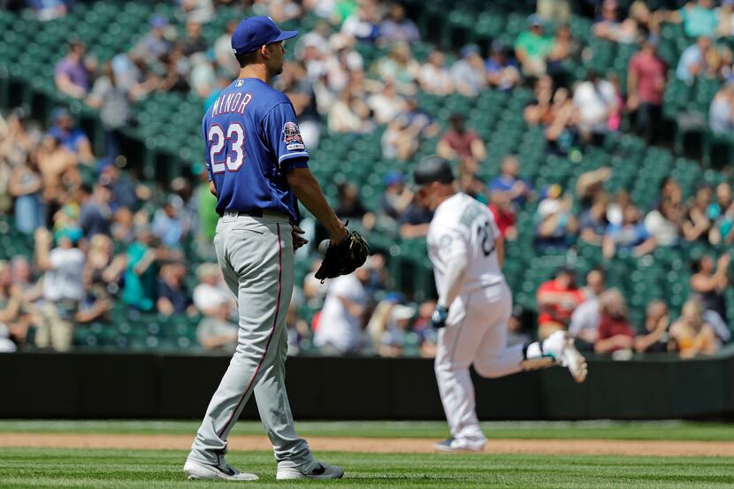 Texas Rangers starting pitcher Mike Minor (23) watches as Seattle Mariners' Daniel...