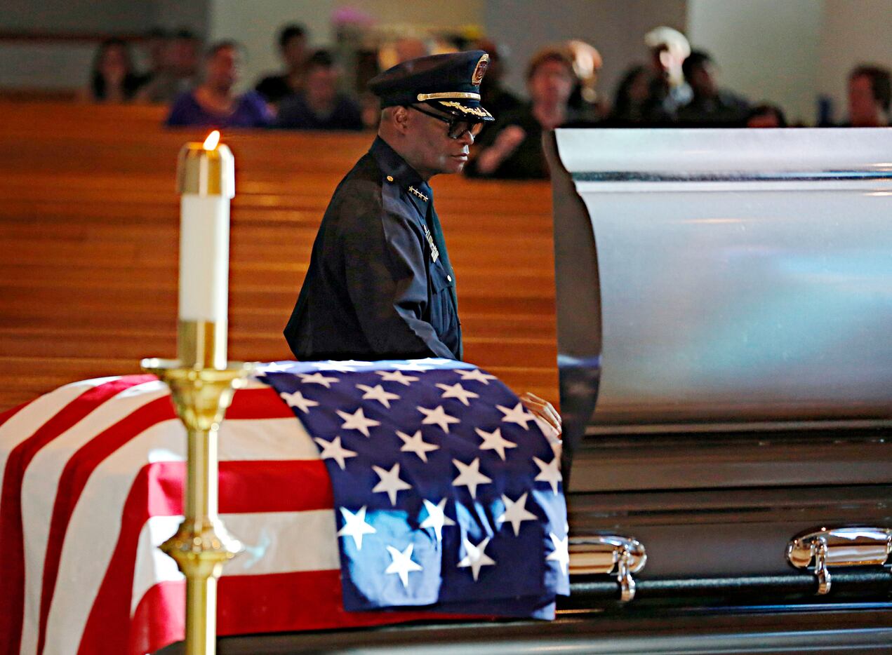 Dallas Police Chief David Brown placed his hand on the casket of slain Dallas police Sgt....
