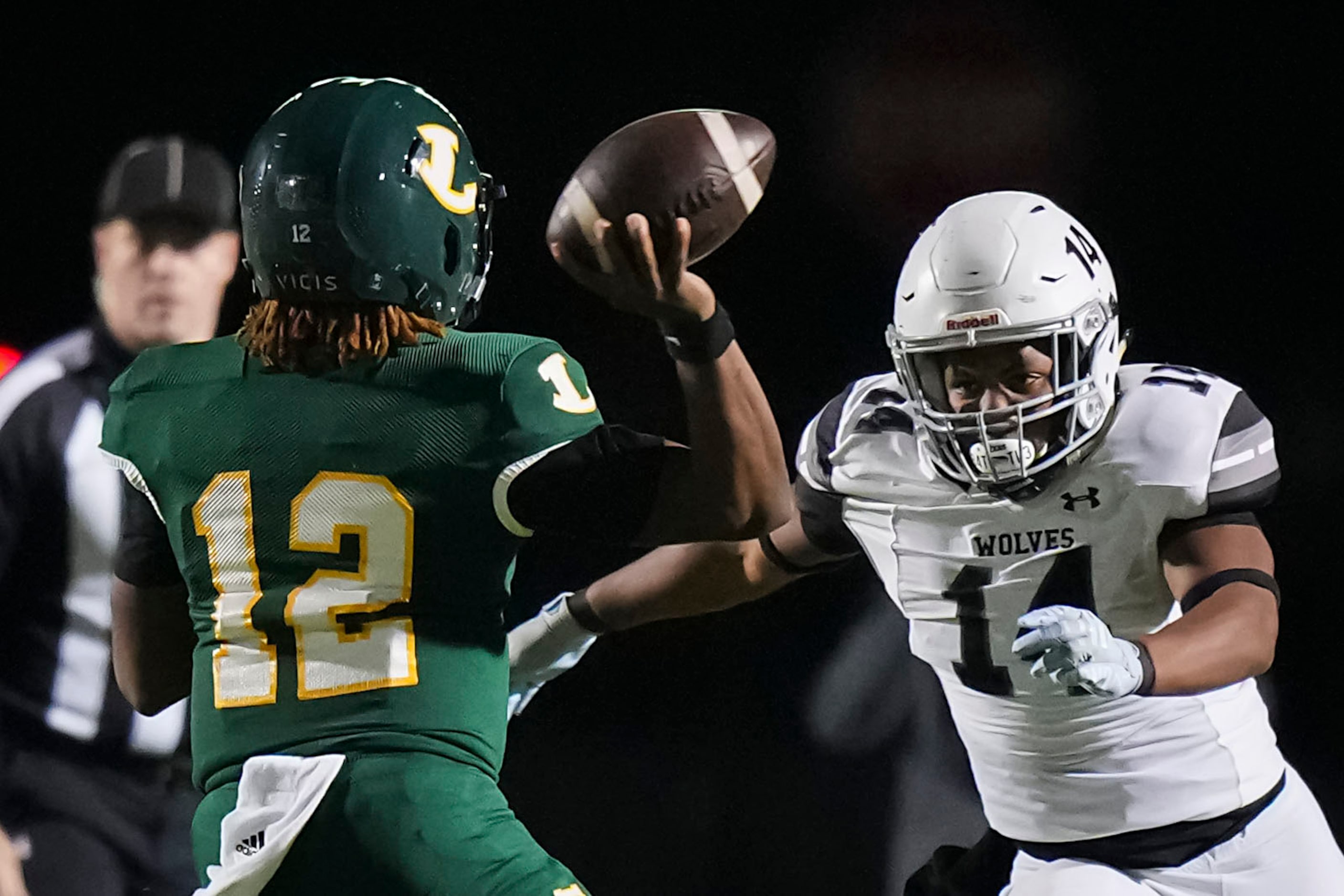 Longview quarterback  Jordan Allen (12) throws a pass under pressure from Mansfield...