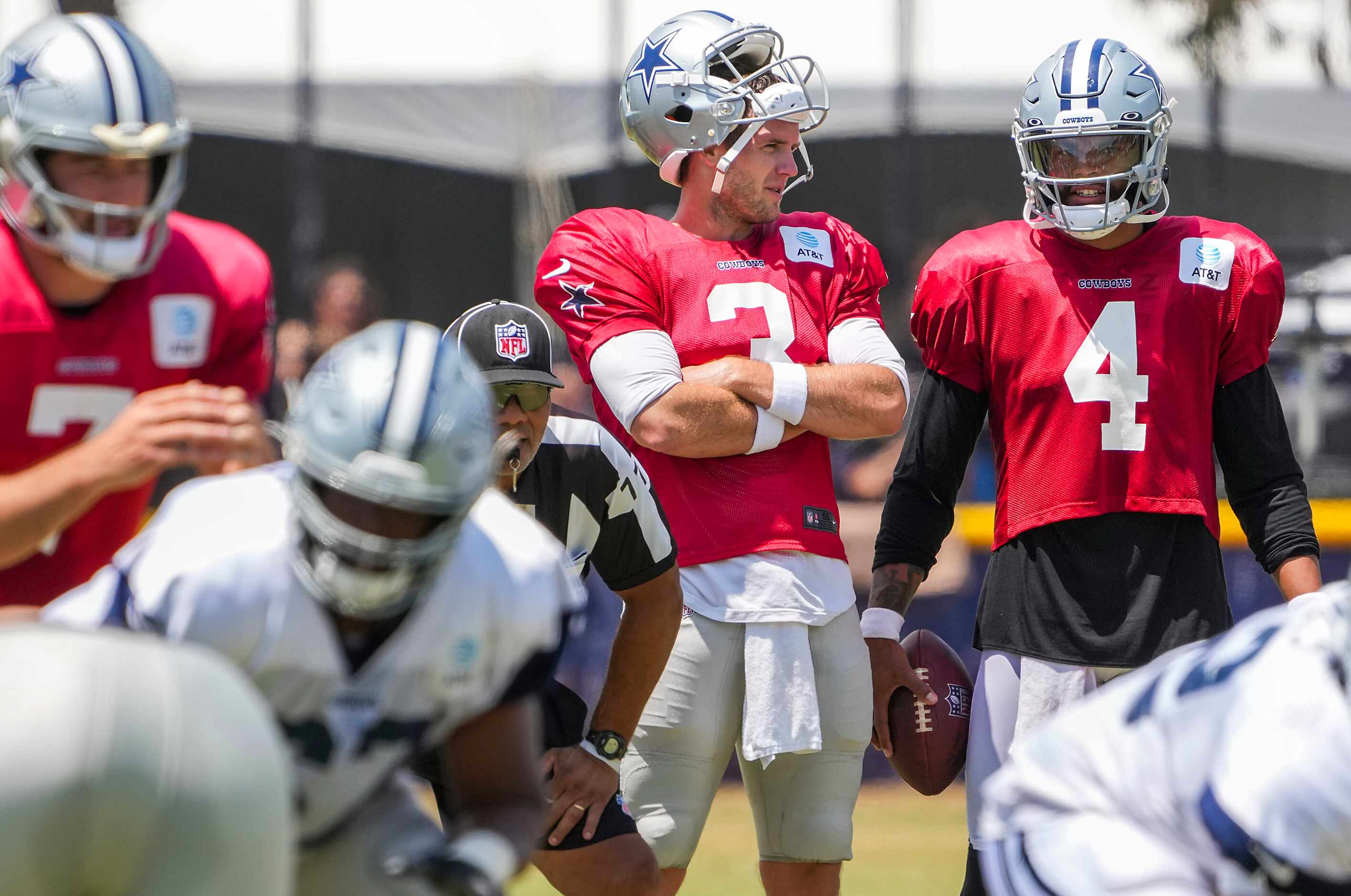 Dallas Cowboys quarterback Dak Prescott (4), who sat out of team drills, talks with...
