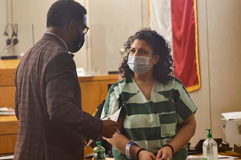 Defense lawyer Heath Harris chats with Nina Marano during a hearing in the 282nd District...