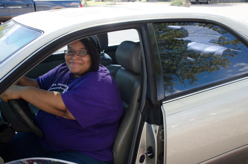 Denton resident and single mother Toni Brown beams from the front seat of her new Lexus,...