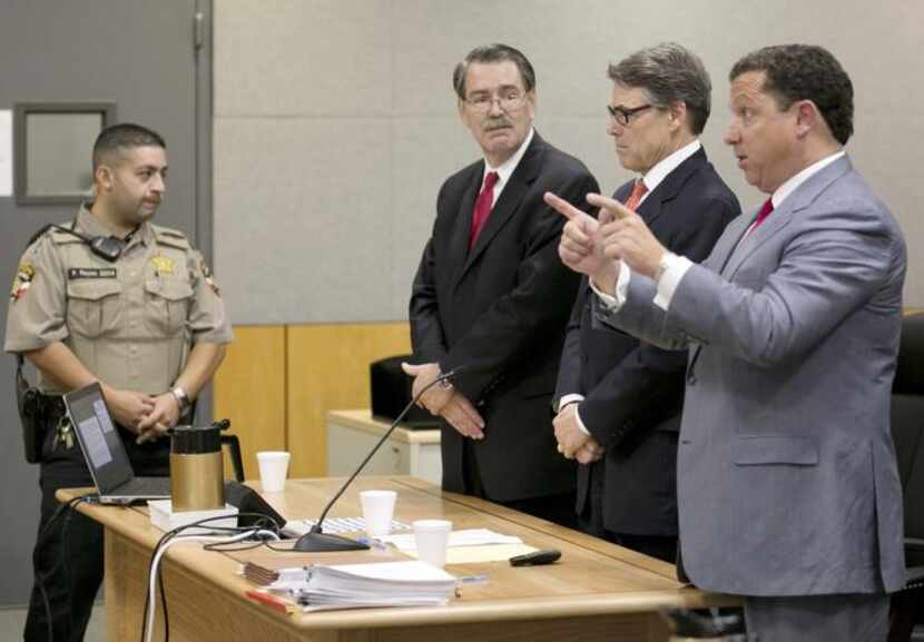 Gov. Rick Perry’s lawyer  Tony Buzbee (right), accompanied by Perry and his other lawyer...