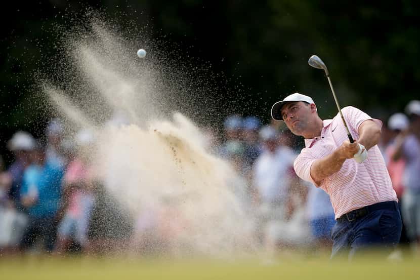 Scottie Scheffler hits from the bunker on the 12th hole during the first round of the U.S....