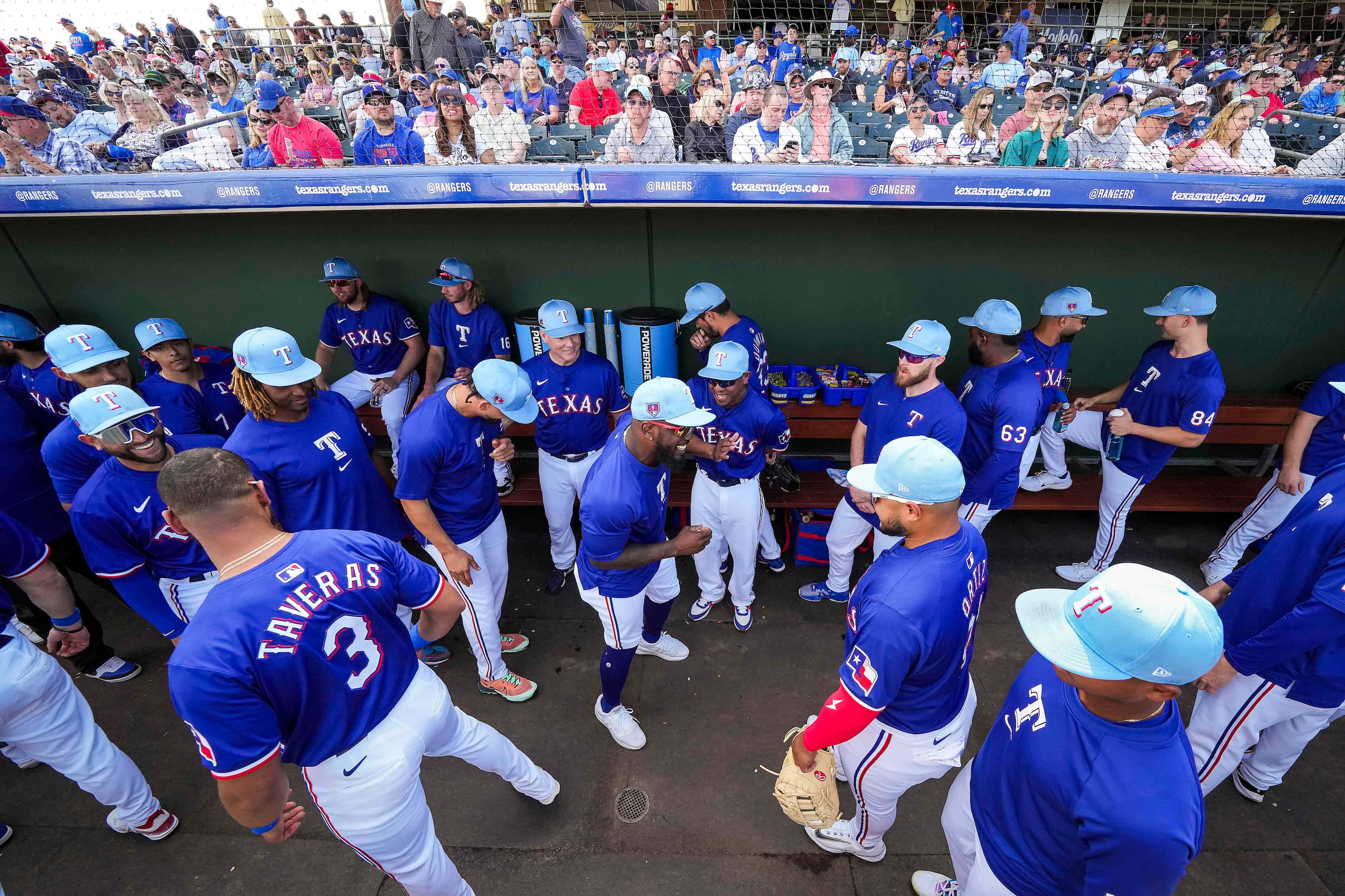 Texas Rangers outfielder Adolis García (center) does a dance in the dugout before a spring...