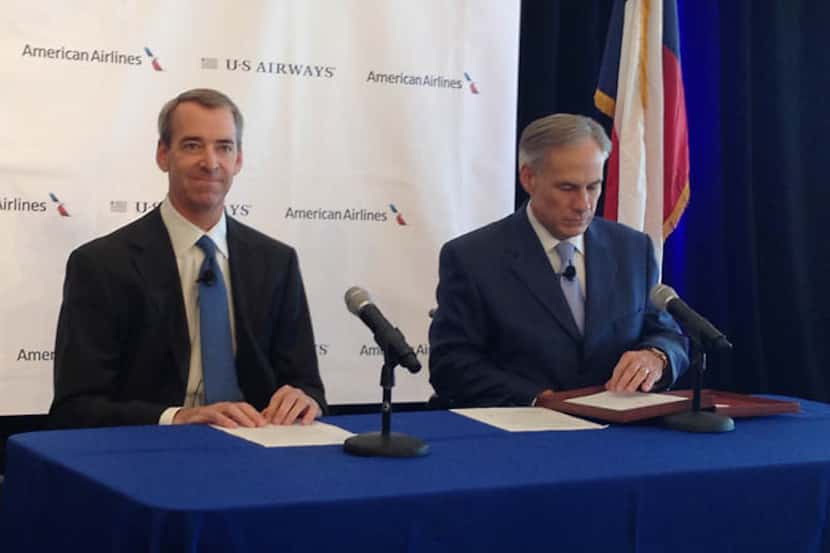 American Airlines CEO Tom Horton (left) and Texas Attorney General Greg Abbott sit at the...