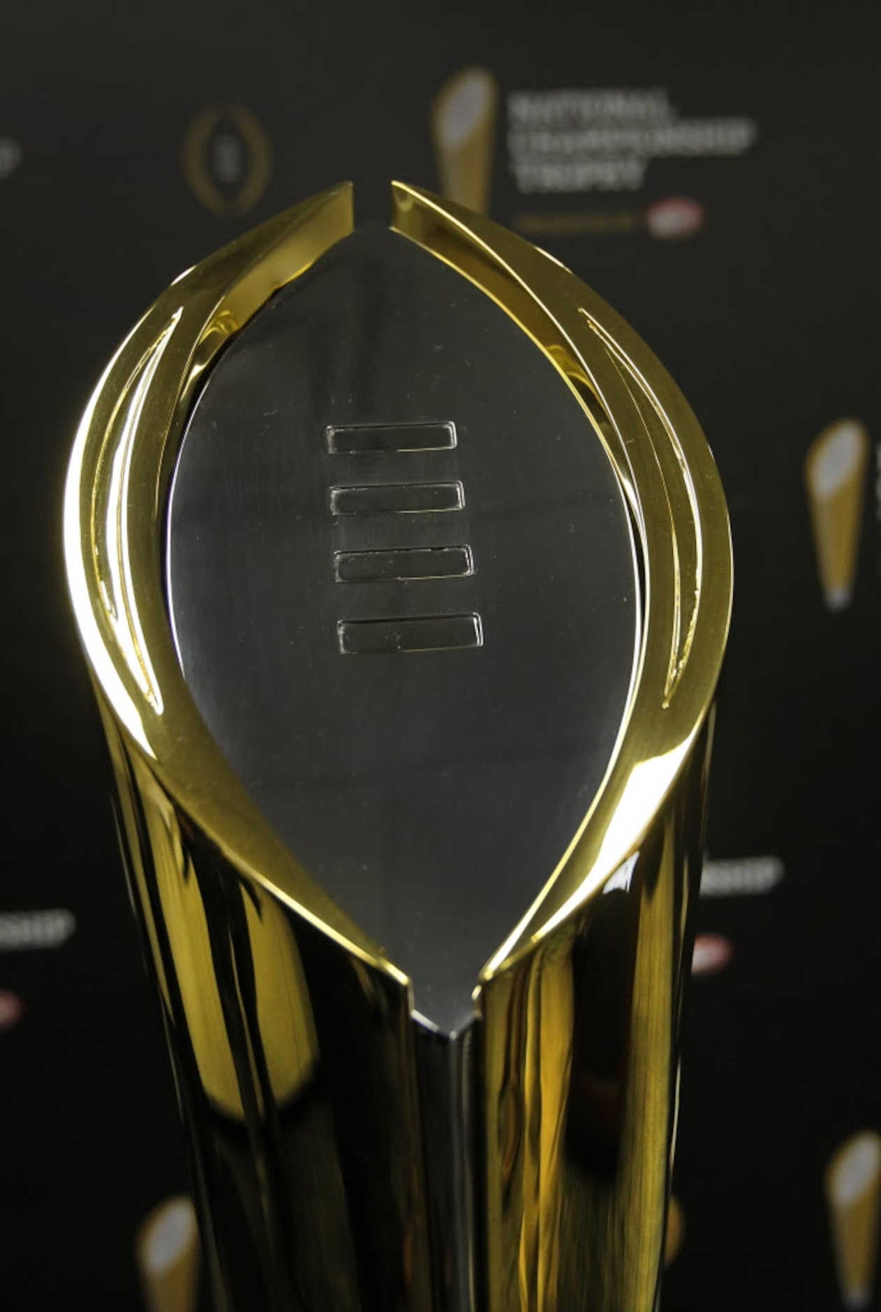 The new national championship trophy for the College Football Playoff is unveiled at a press...