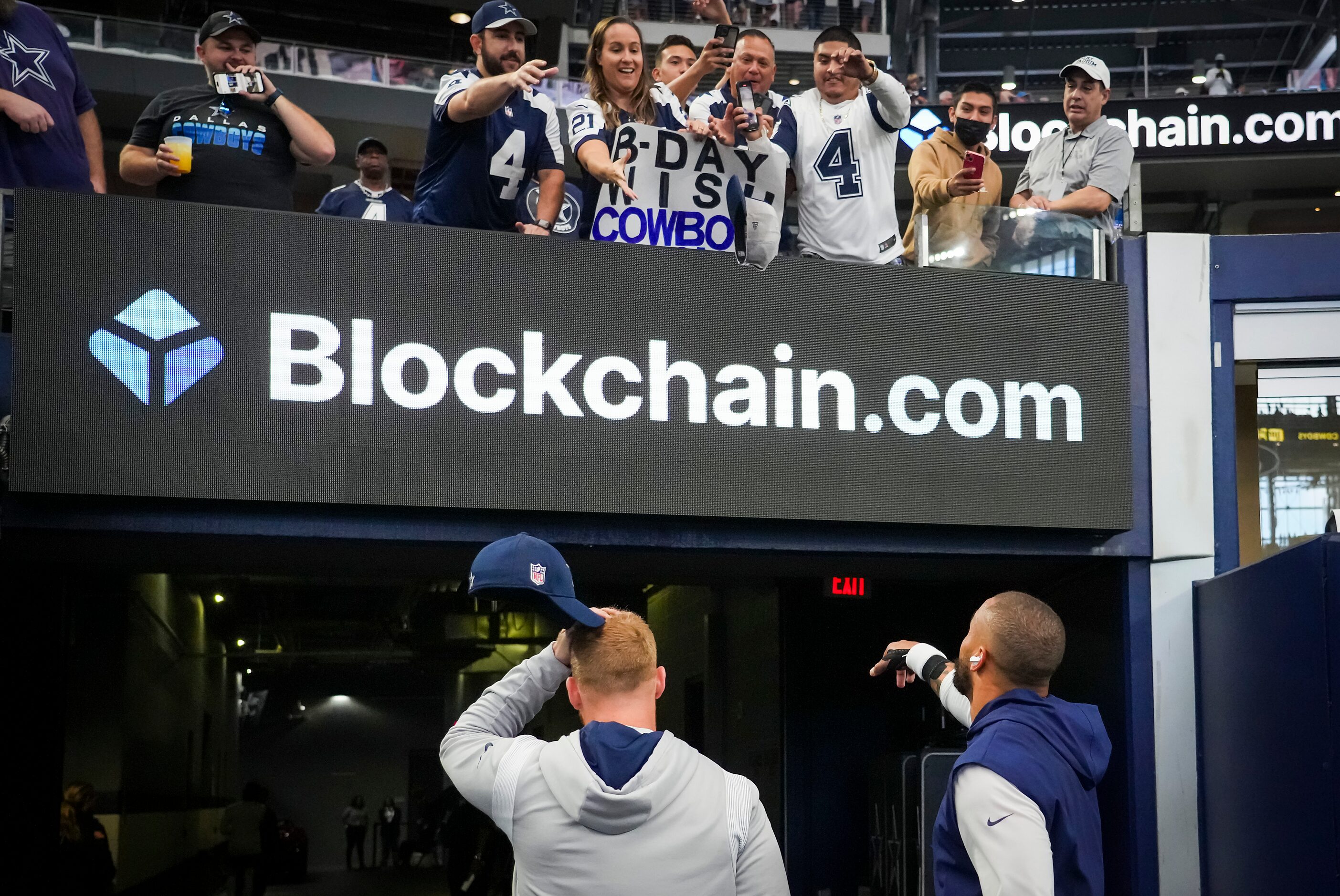 Dallas Cowboys quarterback Dak Prescott tosses his cap to the crowd after warming up before...