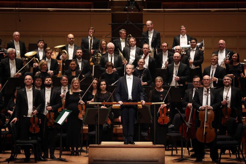 Dallas Symphony Orchestra music director-designate, Fabio Luisi (center), acknowledges the...