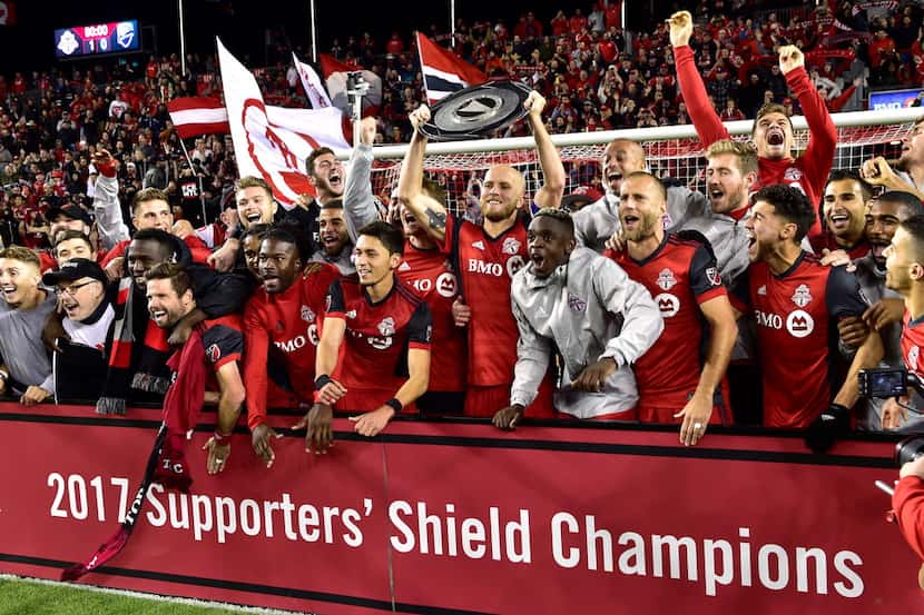 Toronto FC celebrates with the Supporters' Shield following their win over the Montreal...