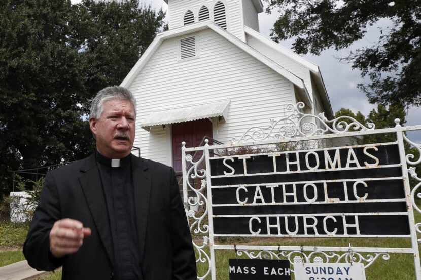 The Rev. Greg Plata speaks  outside St. Thomas Catholic Church in Lexington, Miss.,  about...