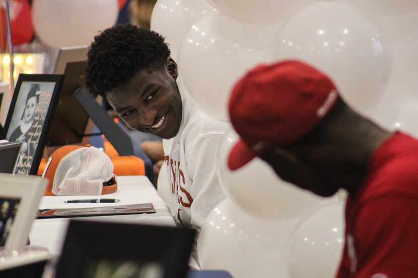 Plano Prestonwood's Dondreone Kennedy (left) smiles at teammate Tarris Murray as the two...