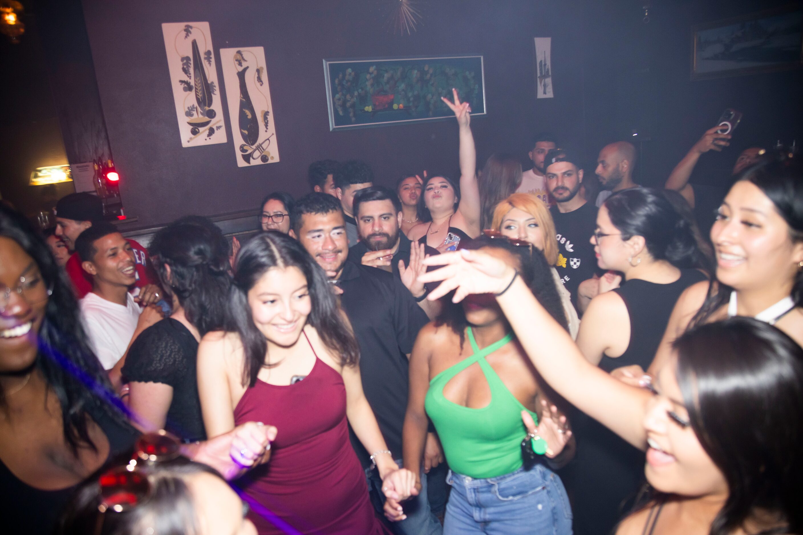 People dance during the Cumbia Dance Party event hosted at Cheapsteaks in the Deep Ellum...