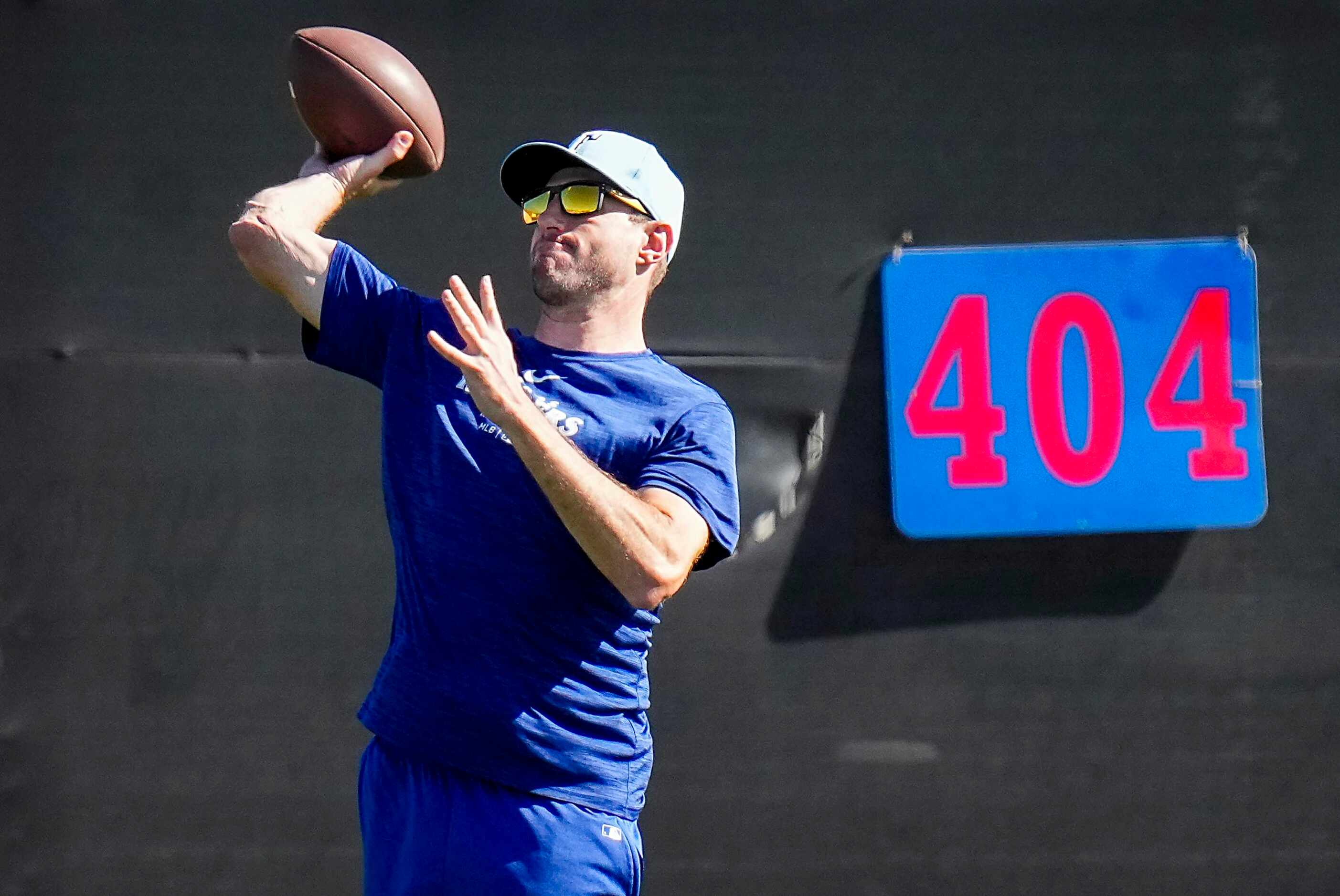 Texas Rangers pitcher Max Scherzer tosses a football in the outfield during a spring...