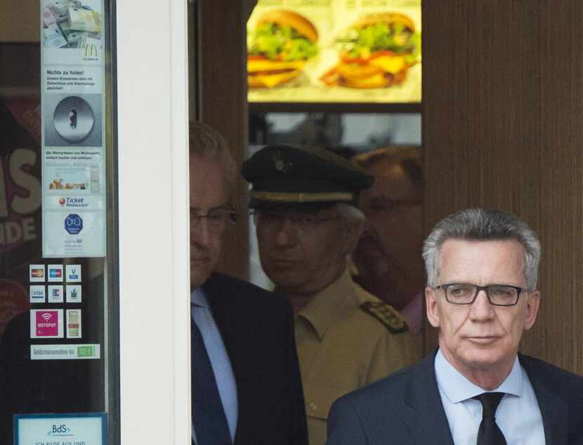 German Interior Minister Thomas de Maiziere leaves the McDonald's Saturday where the...