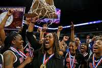 Coach LaJeanna Howard holds the trophy after Duncanville won the Class 6A state championship...
