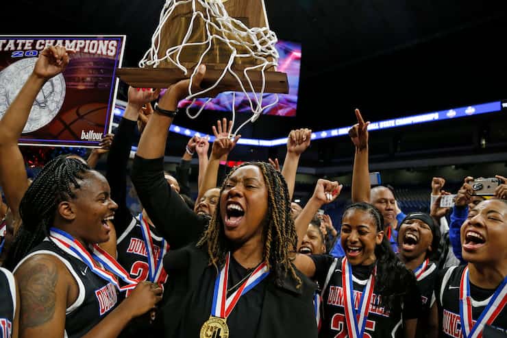 Coach LaJeanna Howard holds the trophy after Duncanville won the Class 6A state championship...