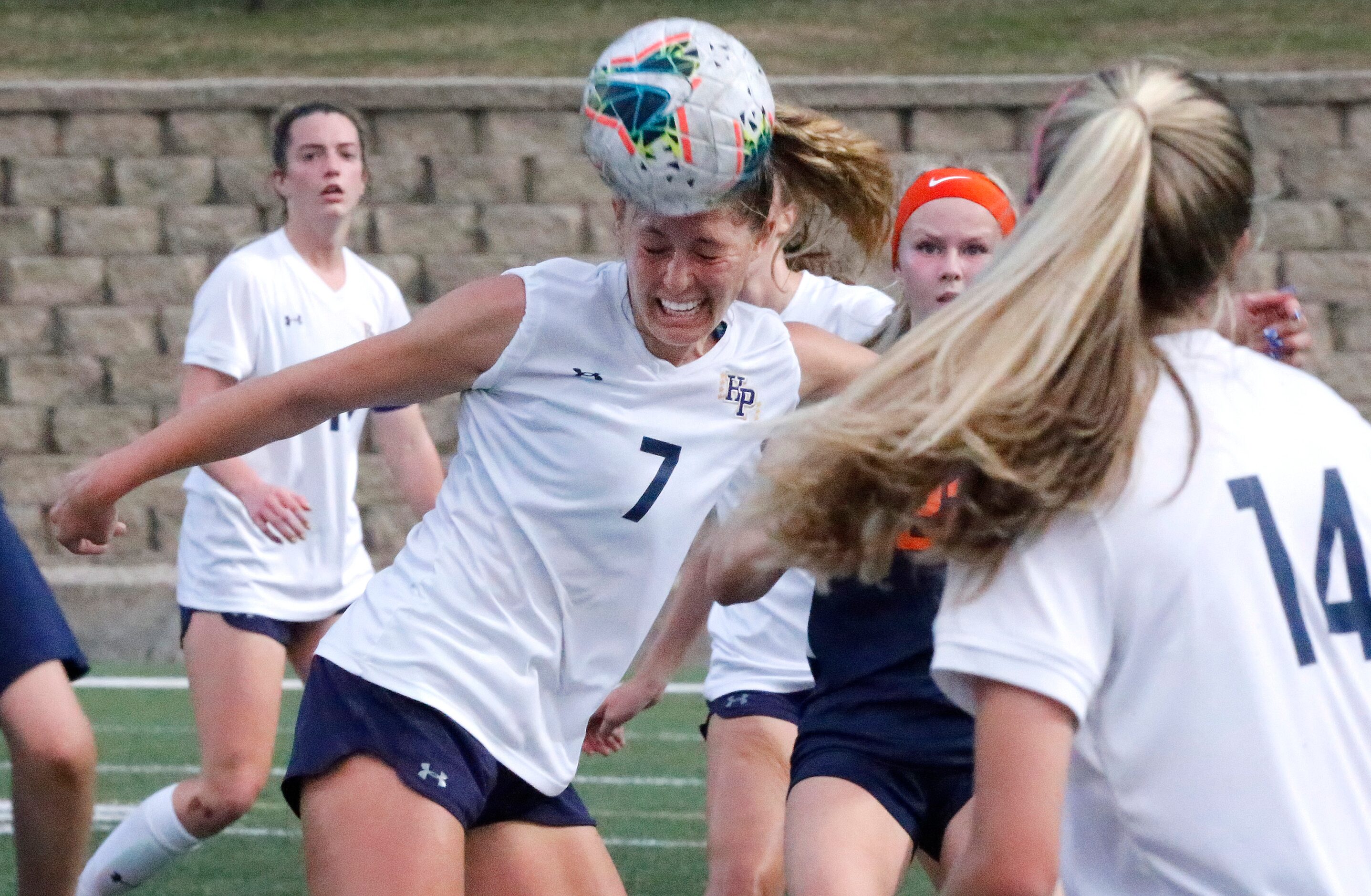 Highland Park midfielder EmJ Cox (7) heads the ball on an inbounds throw during the first...