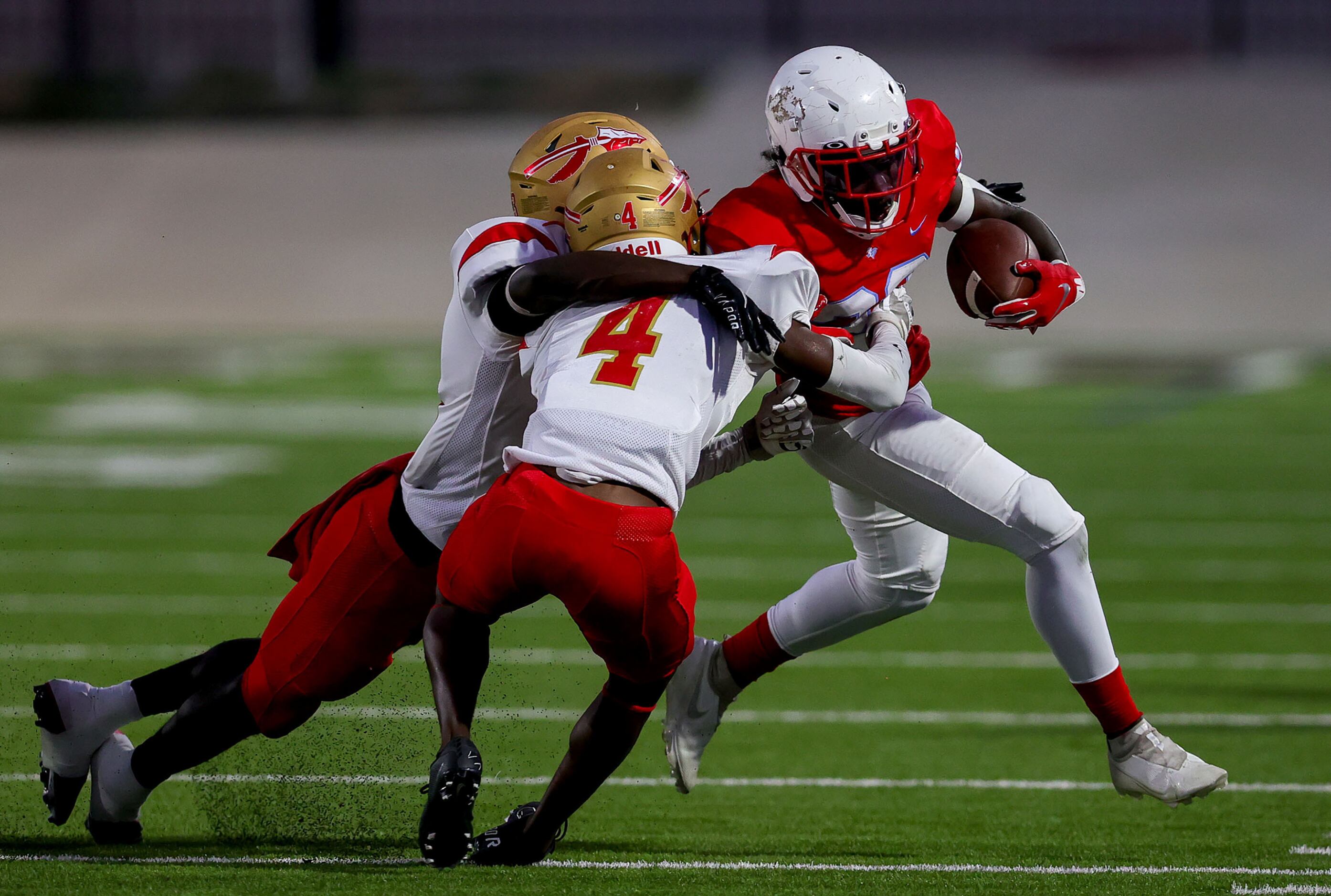 Skyline running back La'Monya Woods (R) gets stopped on the play by South Grand Prairie...