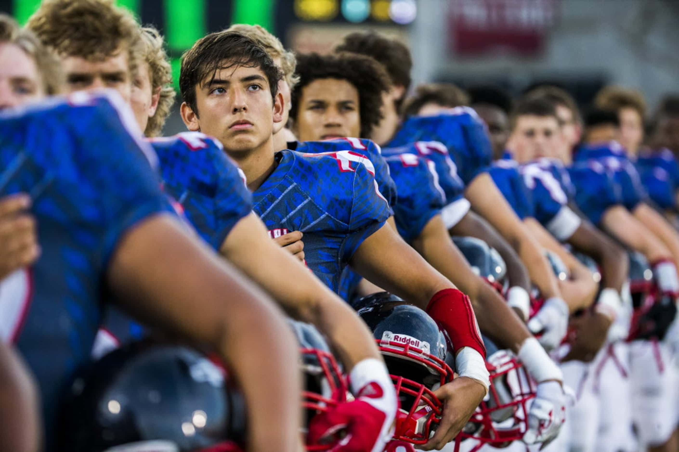 Frisco Centennial linebacker Jarred Saucedo (45) looks up at an American flag while standing...