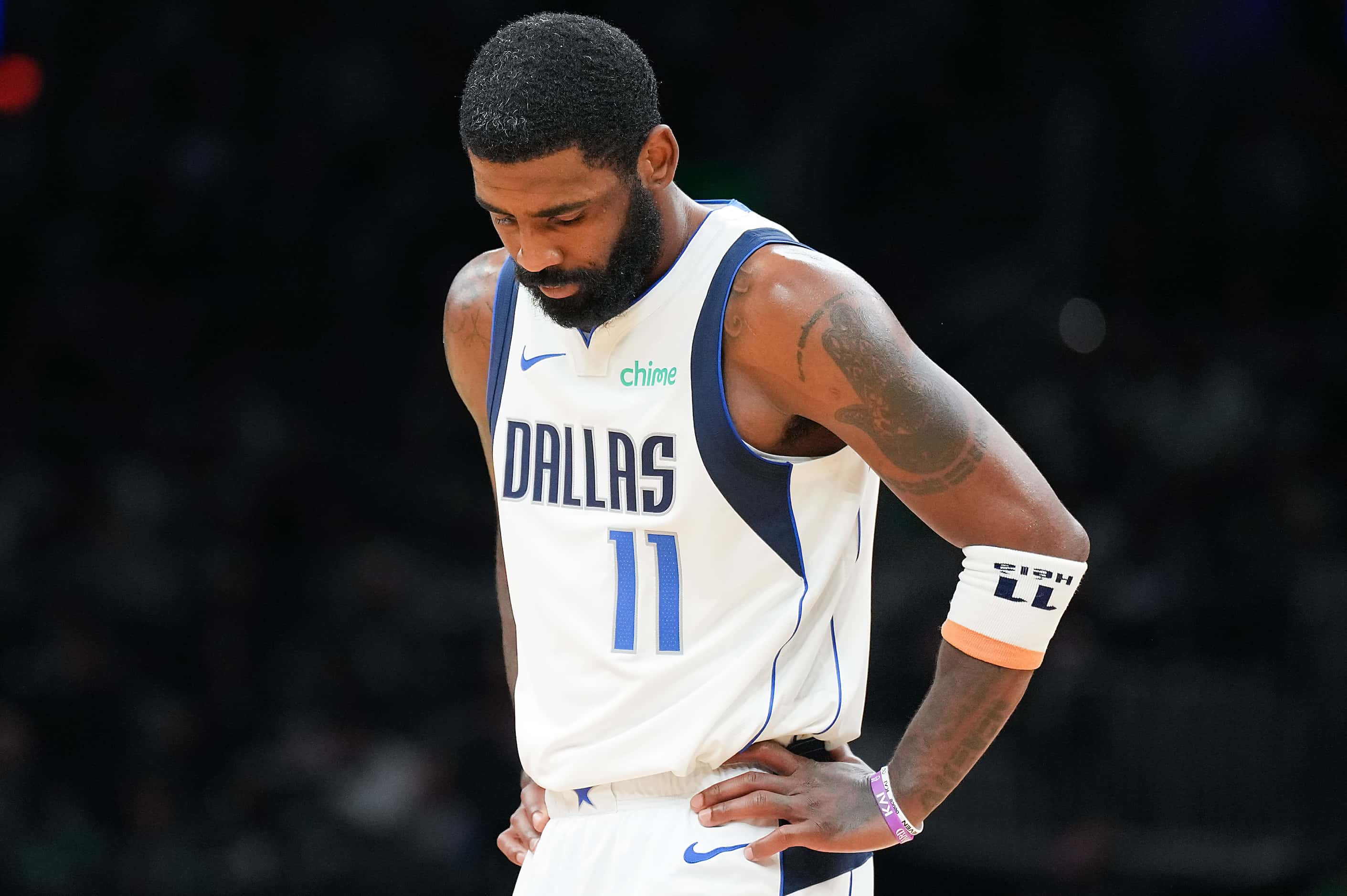Dallas Mavericks guard Kyrie Irving looks down during a stop in play in the second half in...