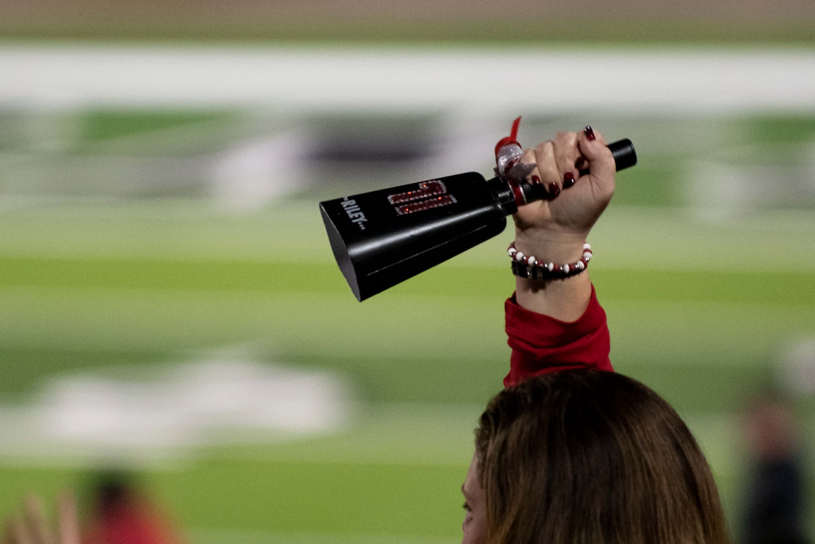 A Melissa fan rings a cow bell during a third down play at the Class 4A Division I...