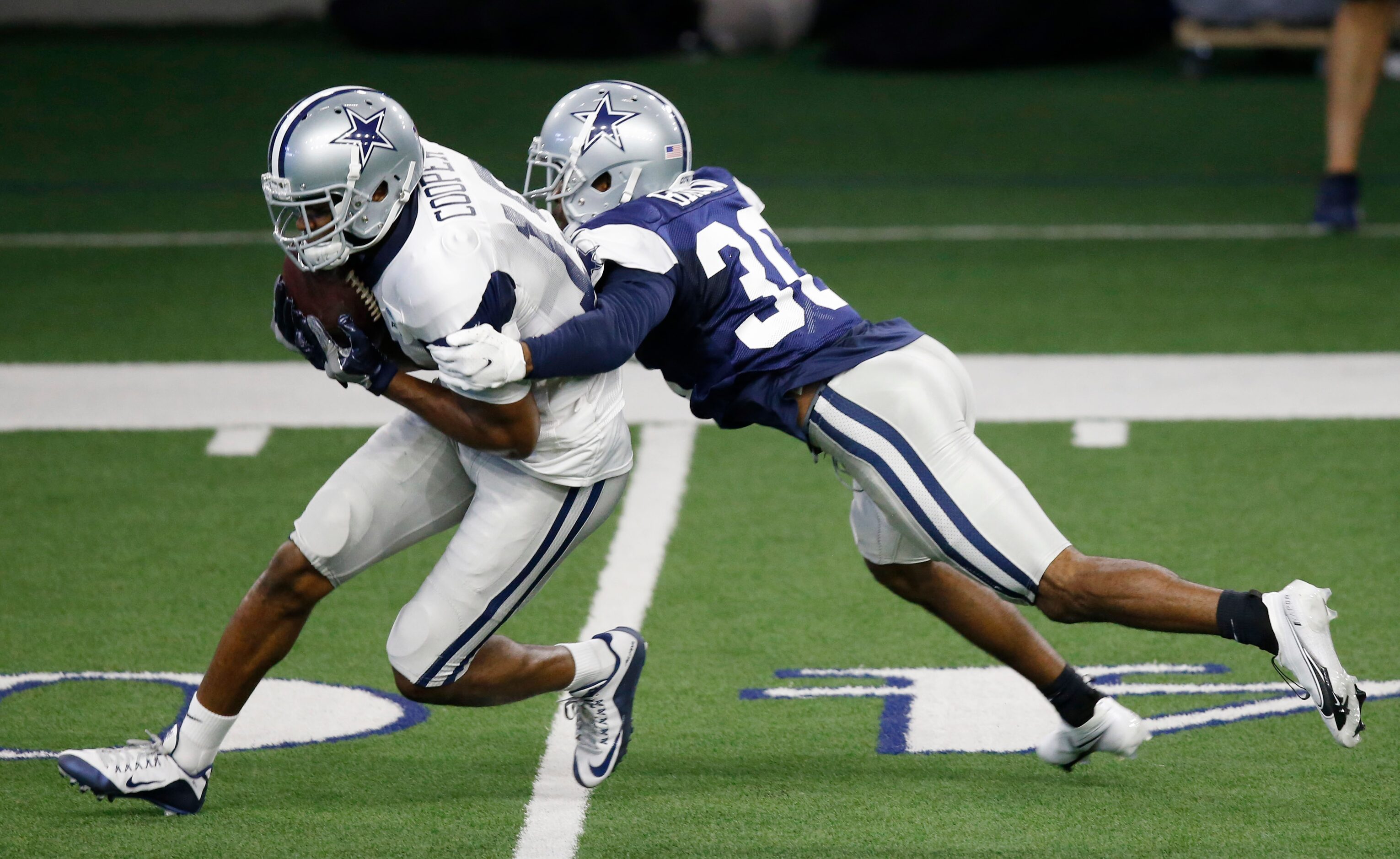 Dallas Cowboys wide receiver Amari Cooper (19) catches the ball in front of Dallas Cowboys...