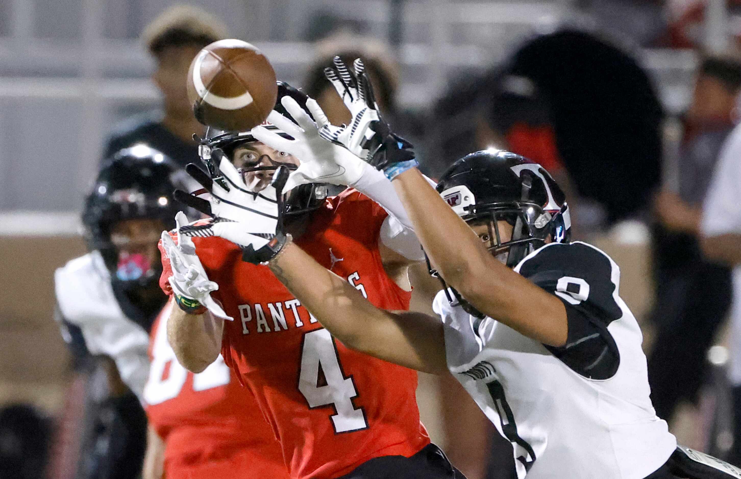 Euless Trinity defender Tovo Asaeli, right, breaks up a pass intended for Colleyville...