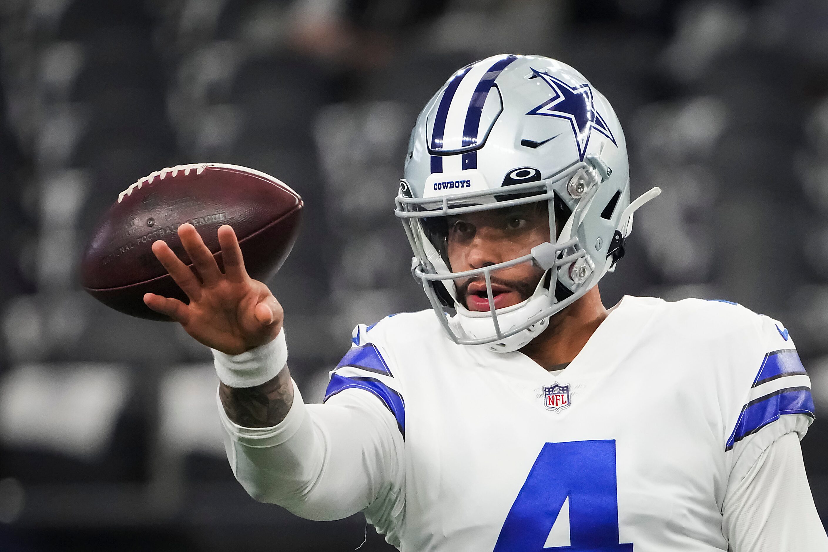 Dallas Cowboys quarterback Dak Prescott (4) warms up before an NFL football game against the...