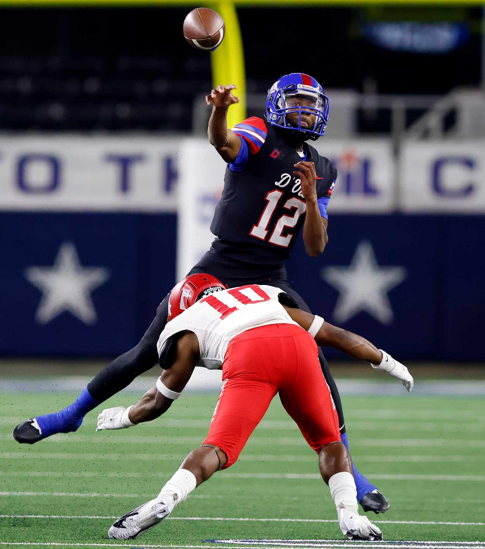 Duncanville quarterback Keelon Russell (12) releases a first quarter pass before being...