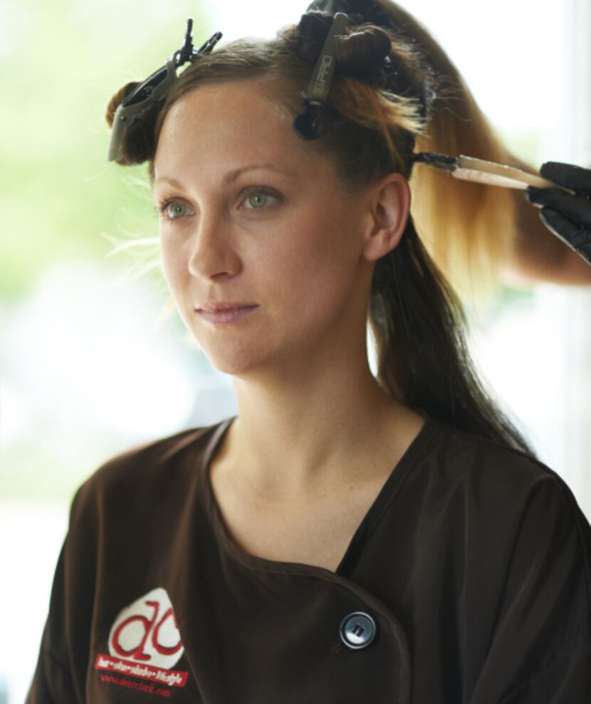 Tiffany Hicks with clips in her hair as color is applied.