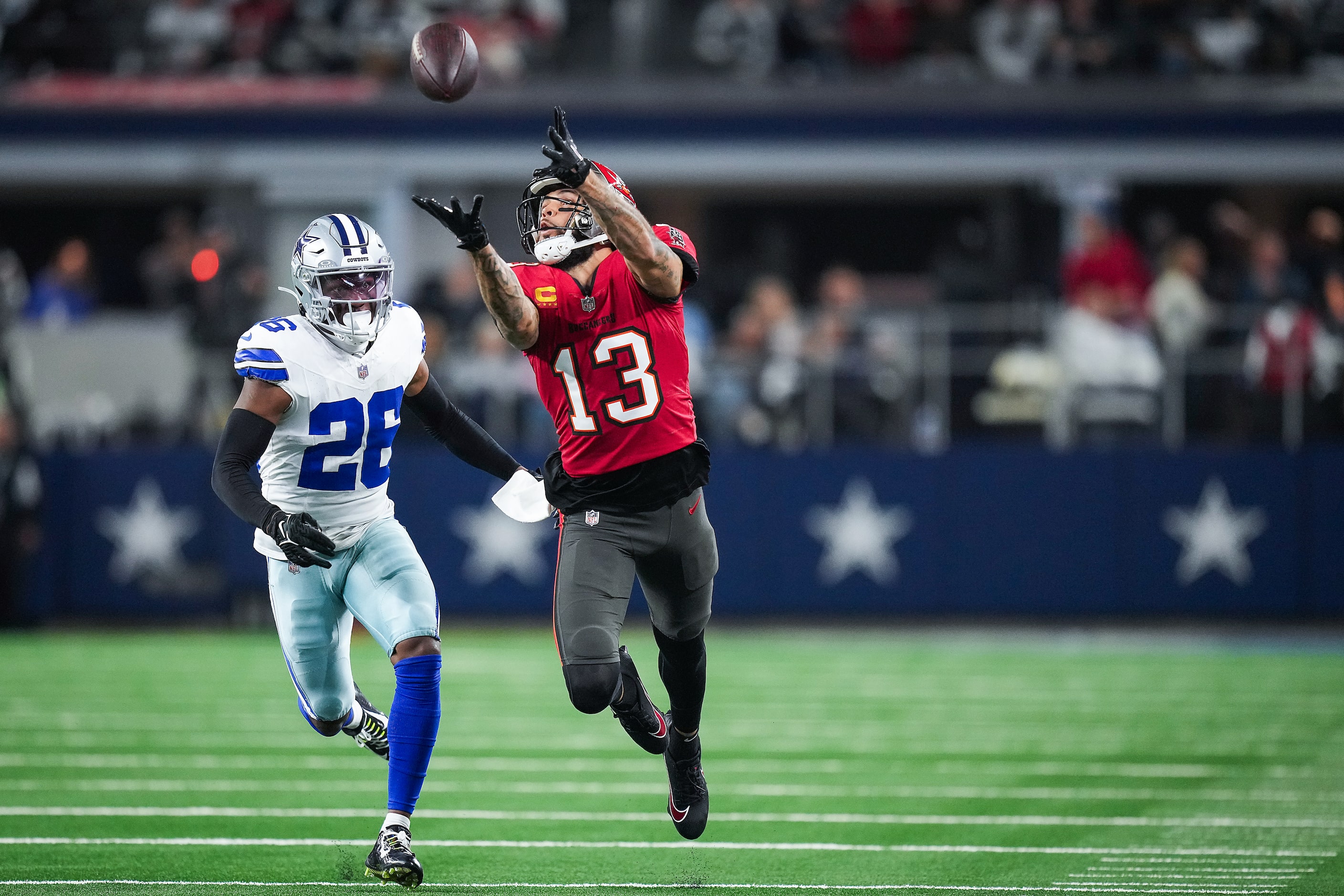 Tampa Bay Buccaneers wide receiver Mike Evans (13) hauls in a long pass as Dallas Cowboys...