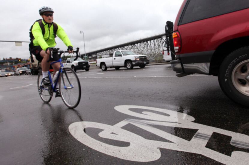 A bicyclist commutes during rush hour in Seattle. A poll found only 21 percent trust people...