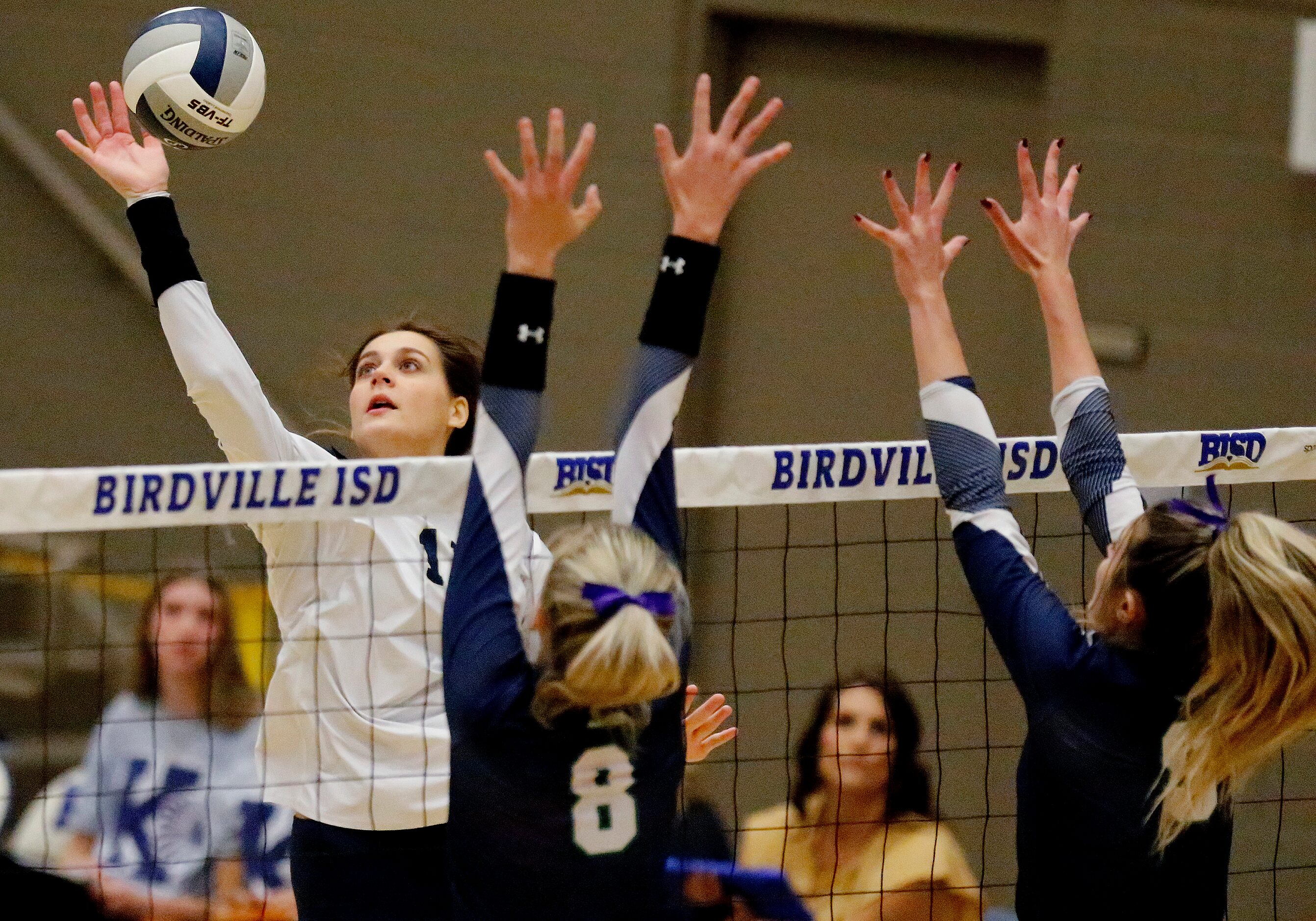 Keller High School outside hitter Melanie McGann (11) gets a hit as V.R. Eaton High School...