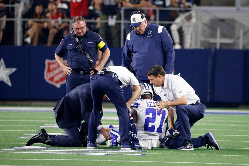 Dallas Cowboys head coach Mike McCarthy, top center, and staff check on safety Jayron Kearse...